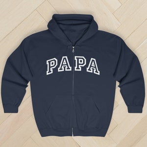 May include: A navy blue zip-up hoodie with a white "PAPA" graphic in a collegiate font.