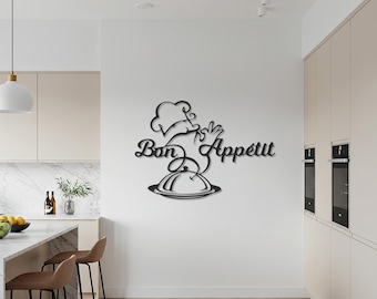 May include: Black metal wall art featuring the phrase "Bon Appétit" in elegant script, along with a chef's hat, hand, and a covered serving dish. The artwork is mounted on a white wall in a modern kitchen setting.