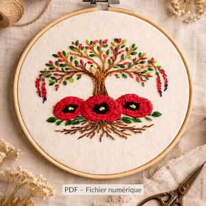 May include: Embroidered tree and poppy design in a wooden embroidery hoop. The tree has green and red leaves, with three red poppies at the base. The text "PDF - Fichier numérique" is at the bottom of the image.