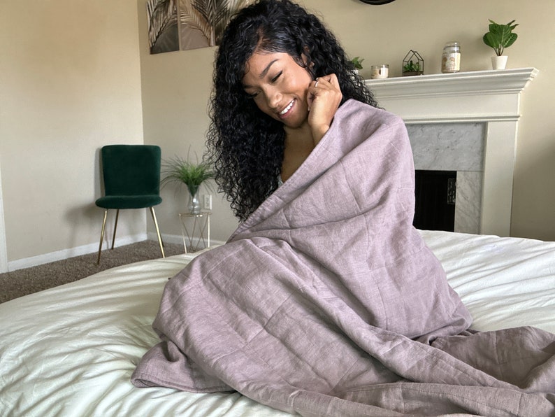 women covered in linen weighted blanket
