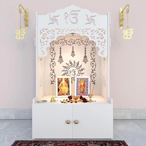 Material: 12 MM thick High Density High Moisture Resistance Board (HDHMR) with Glossy Melamine Finish. Package Content: 9 wooden panels of Temple, Brass Bells & a packet of safety rubbers, Screws, J hooks for Brass Bells.     White wooden pooja mandir with lotus design, Hindu home temple and prayer altar with storage drawers