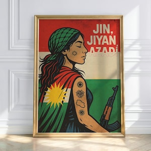 May include: A framed art print featuring a stylized illustration of a woman with a green head covering and a red and green cape. The image includes the text "JIN, JIYAN AZADI" and a rifle. The background features the colors of a flag.