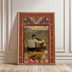 May include: A framed print featuring a couple embracing on a mountain, with a detailed rug-like border. The artwork depicts a couple in traditional attire, set against a backdrop of rolling hills and a floral foreground. The frame is a warm brown.