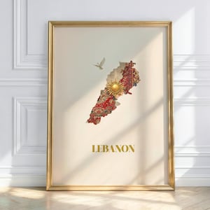 May include: A framed print featuring a map of Lebanon, filled with a red and gold floral pattern. A golden sun and a flying dove are depicted on the map. The word "LEBANON" is printed in gold at the bottom.