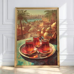 May include: A framed print of a Middle Eastern scene. The artwork depicts a table set with tea glasses, saucers, and a teapot. The background shows a cityscape with palm trees and a body of water. The color palette includes gold, red, and teal.
