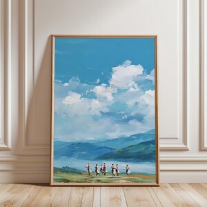 May include: A framed landscape painting shows a bright blue sky with white clouds. Below, rolling blue hills and a green field lead to a group of figures in motion. The artwork is displayed on a wooden floor.
