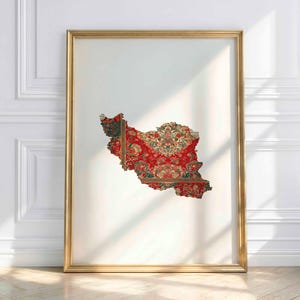 May include: A framed print featuring the shape of Iran, filled with a traditional red and gold Persian rug design. The artwork is set against a white background and framed in gold, creating a striking contrast.