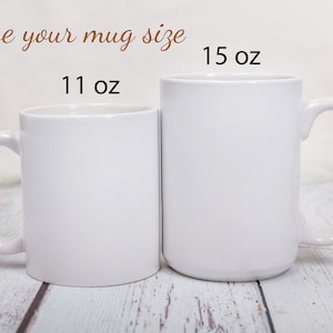 May include: Two white ceramic mugs, one 11 oz and one 15 oz, side by side on a whitewashed wood surface. Choose your mug size.