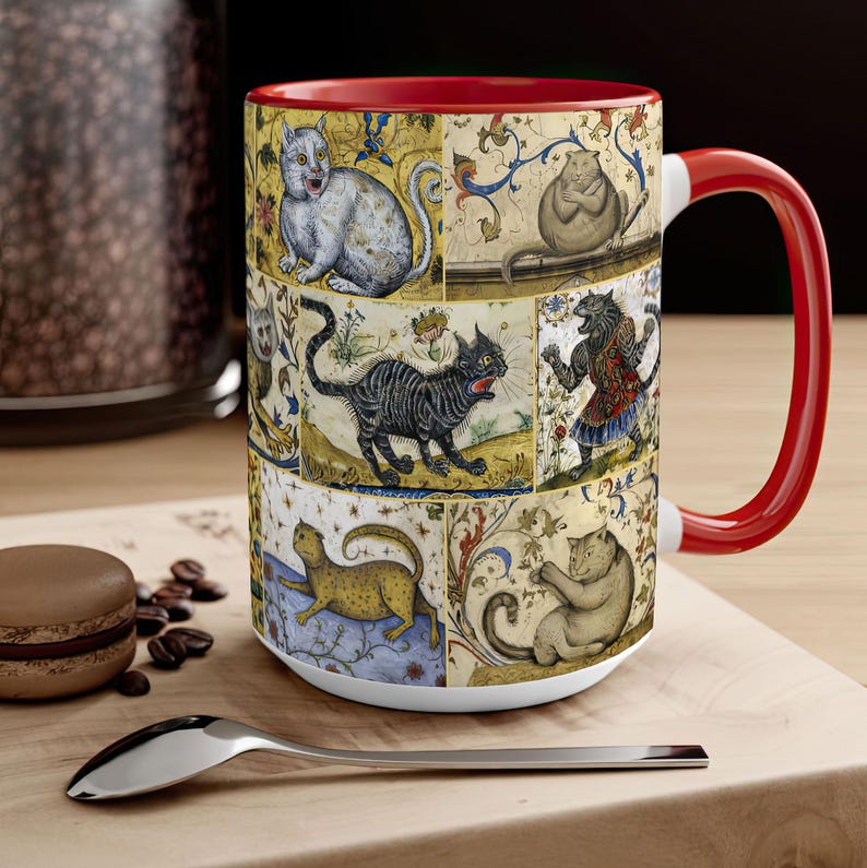 May include: A white ceramic mug with a red rim and handle. The mug features a colorful design of cats in a medieval style. The cats are depicted in various poses, including sitting, standing, and lying down. The background is a yellow and brown pattern.