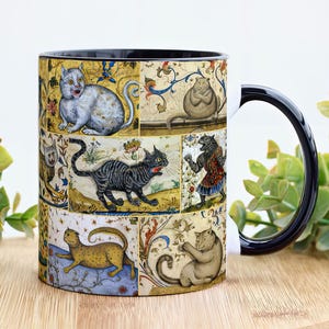 May include: A black ceramic mug with a white handle features a colorful vintage illustration of cats in a medieval style. The design includes a variety of cats in different poses and colors, set against a background of intricate floral patterns.