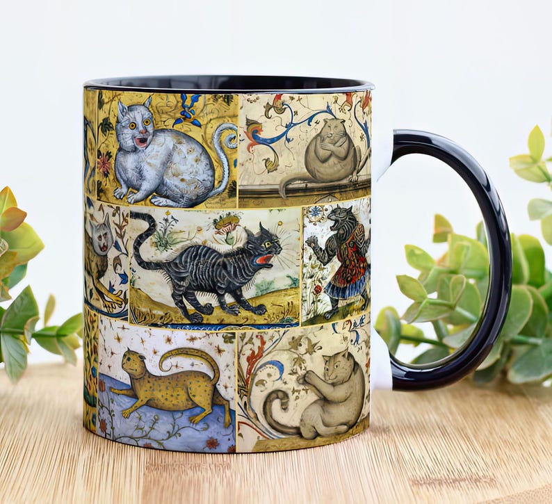 May include: A black ceramic mug with a white handle features a colorful vintage illustration of cats in a medieval style. The design includes a variety of cats in different poses and colors, set against a background of intricate floral patterns.