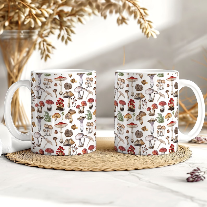 May include: Two white ceramic mugs with a colorful mushroom pattern. The mugs have a white background with a variety of mushrooms in different colors and sizes, including red, brown, white, and purple. The mushrooms are arranged in a random pattern.