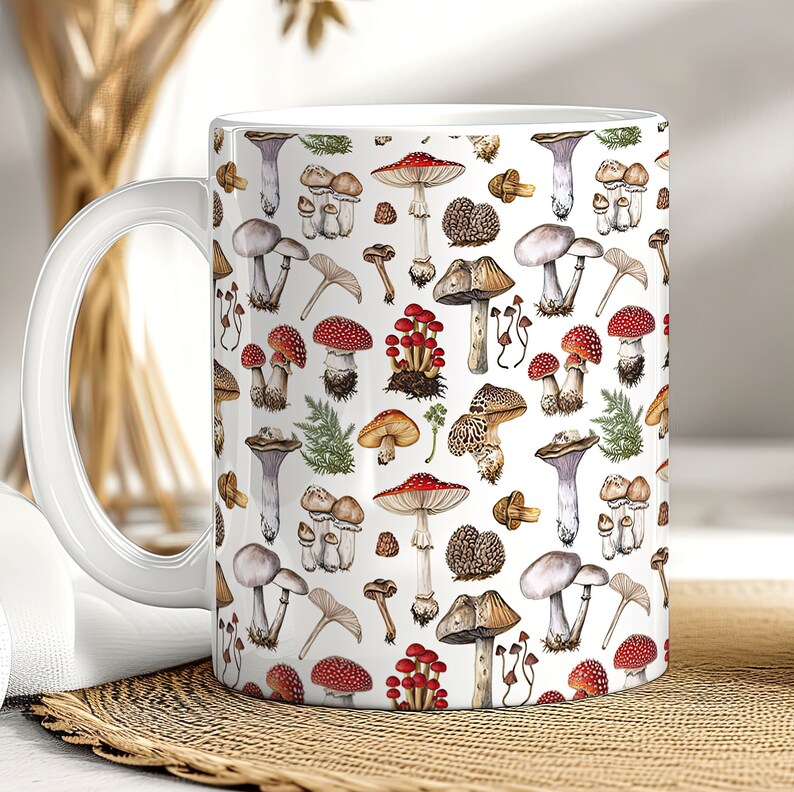 May include: White ceramic mug with a colorful mushroom pattern. The mug features a variety of mushrooms in different shapes, sizes, and colors, including red, brown, and white.