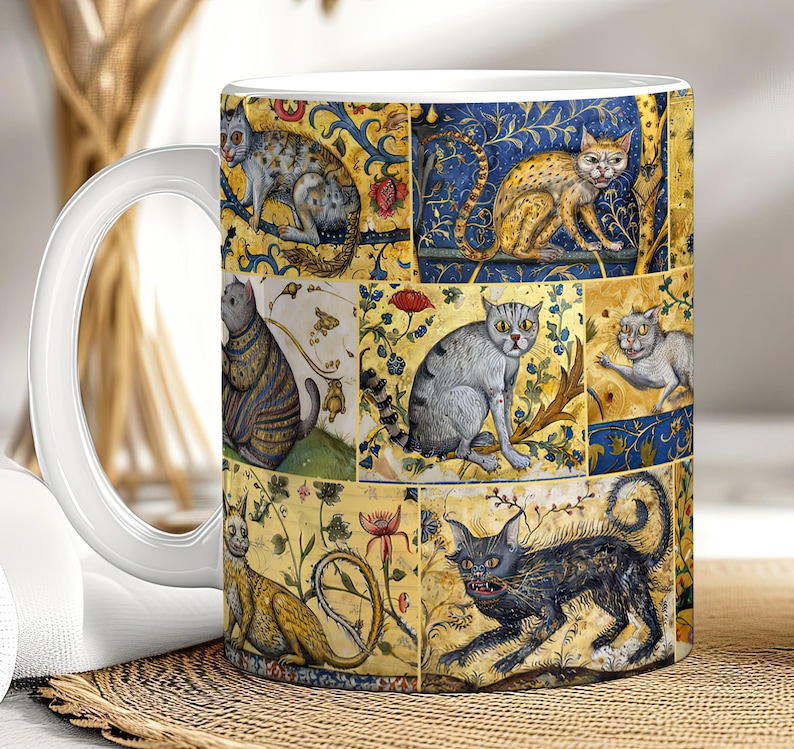 May include: A white ceramic mug with a colorful design featuring multiple cats in a medieval style. The cats are depicted in various poses and surrounded by intricate floral patterns.