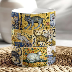 May include: A white ceramic mug with a colorful pattern of cats in a medieval style. The cats are depicted in various poses and colors, with intricate floral designs surrounding them.