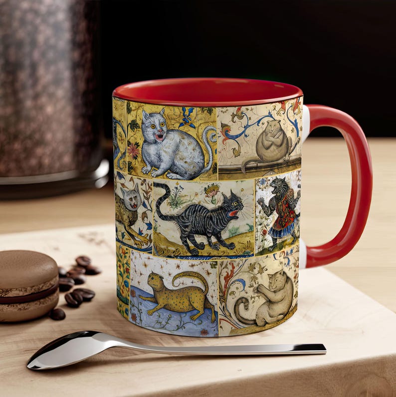 May include: A red and white ceramic mug with a colorful design of cats. The mug features a variety of cats in different poses, including a white cat with black ears, a black cat with a white chest, and a brown cat with a white belly. The mug is decorated with a floral pattern and a gold trim.