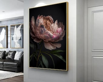 May include: A close-up of a large, pink peony flower with dark green leaves against a black background. The flower is in full bloom and has a delicate, layered texture.