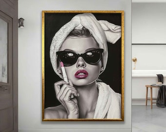May include: A black and white illustration of a woman with a white towel wrapped around her head. She is wearing sunglasses and holding a pink lipstick. The background is black.
