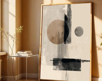 May include: Abstract art print in a gold frame. The artwork features geometric shapes, including circles and rectangles, in neutral tones of beige, gray, and black. Vertical lines and brushstrokes add texture to the design. The artwork is leaning against a wall.