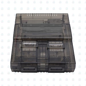 May include: A translucent grey video game console, revealing internal components through its clear plastic shell. It has controller ports and a top vent, presenting a retro gaming design. The console's dimensions are approximately 24 cm x 20 cm x 5 cm.