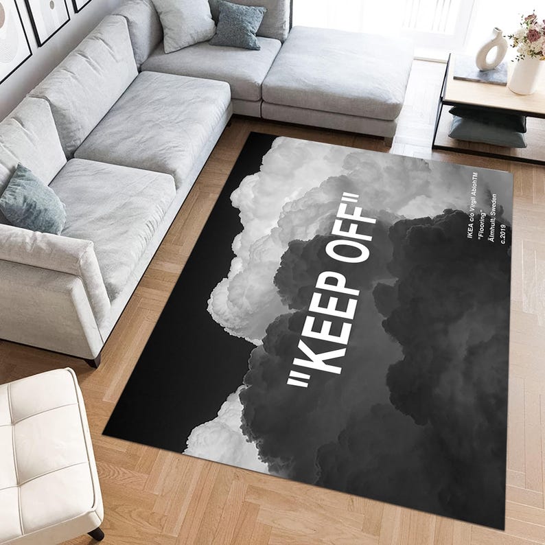 May include: Black and white area rug with a cloud design and the text "KEEP OFF" in white. The rug has a modern and abstract design.