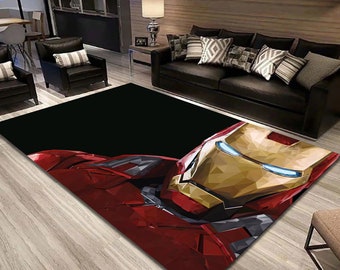 May include: A black and red area rug with a geometric design of Iron Man's face. The rug is in a living room setting with a couch and chairs.