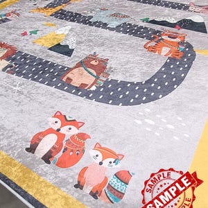 May include: A gray and yellow rug with a whimsical design featuring various animals, including foxes, bears, tigers, and zebras. The animals are depicted in a cartoon style and are surrounded by a black and white dotted path. The rug has a yellow border and a white border.