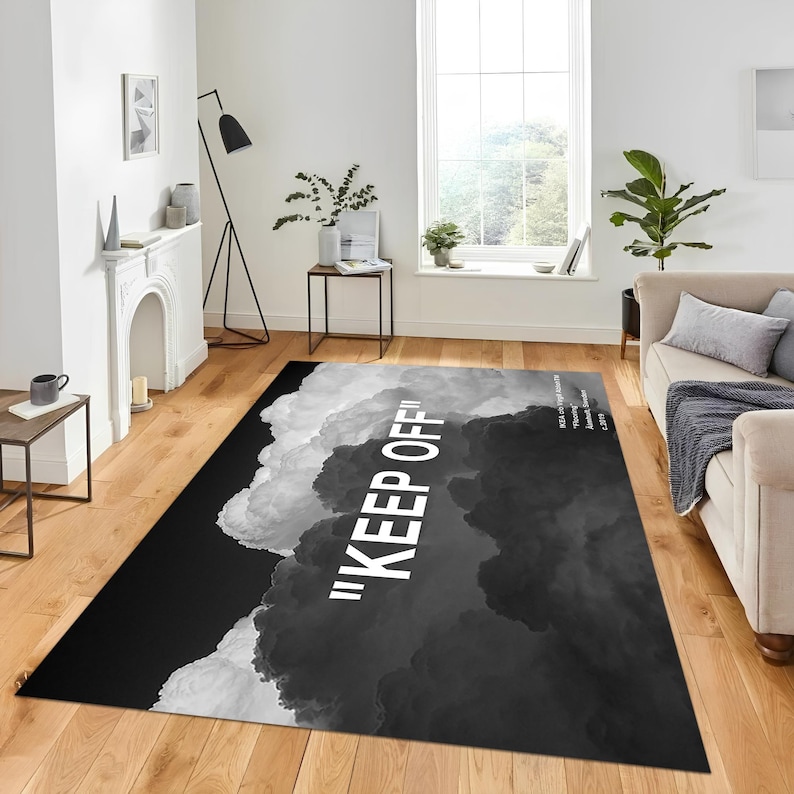 May include: Black and white area rug with a cloud design and the text "KEEP OFF!" in white.