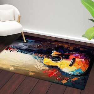May include: A rectangular area rug featuring a colorful, abstract painting of an acoustic guitar. The artwork uses a palette of yellow, red, blue, and purple. The rug is placed on a dark wood floor.