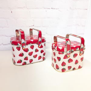 Pair of Vintage Strawberry small  Lunchboxes metal handles . One is 6in X  5in other 5in X 3.5in made in Hong Kong . In good condition .