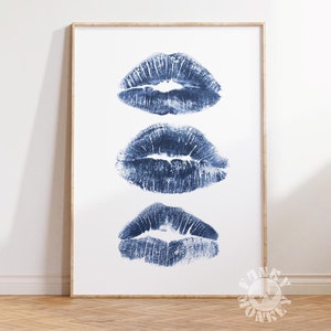 May include: Three blue lipstick prints in a vertical row on a white background. The prints are slightly faded and have a textured look.