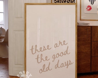 May include: A framed print with a white background and the text "these are the good old days" written in brown cursive script.