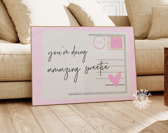 May include: Pink and white postcard with the text "you're doing amazing sweetie" and a pink heart.
