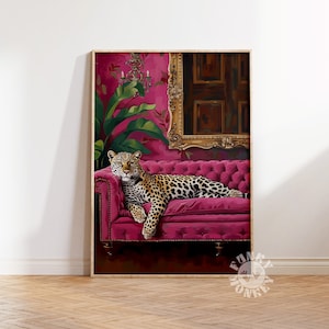 May include: A leopard lounges on a plush, pink velvet sofa in a luxurious, ornate setting. The sofa is decorated with gold studs and the room features a large, gold-framed mirror and lush green plants.