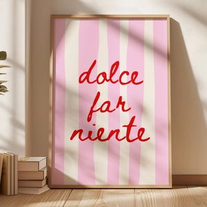 May include: A pink and white striped poster with the text "dolce far niente" in red cursive writing.