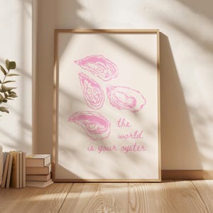 May include: Pink and white printable art print with a quote that says "the world is your oyster" and a graphic of four pink oysters.