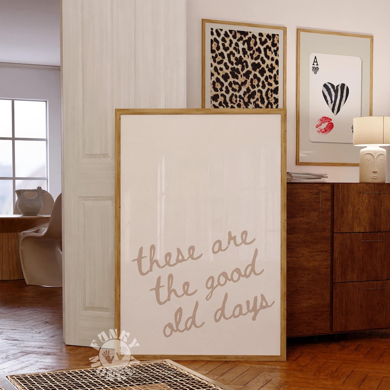 May include: A framed print with a white background and the text "these are the good old days" written in brown cursive script.