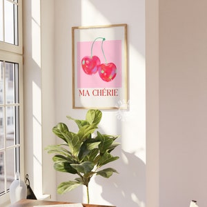 Puede incluir: Una impresi&oacute;n enmarcada con un fondo rosa y dos cerezas rojas. El texto "MA CH&Eacute;RIE" est&aacute; impreso en rojo debajo de las cerezas.
