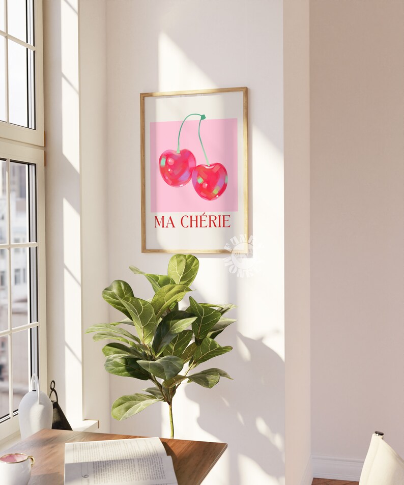 Puede incluir: Una impresi&oacute;n enmarcada con un fondo rosa y dos cerezas rojas. El texto "MA CH&Eacute;RIE" est&aacute; impreso en rojo debajo de las cerezas.