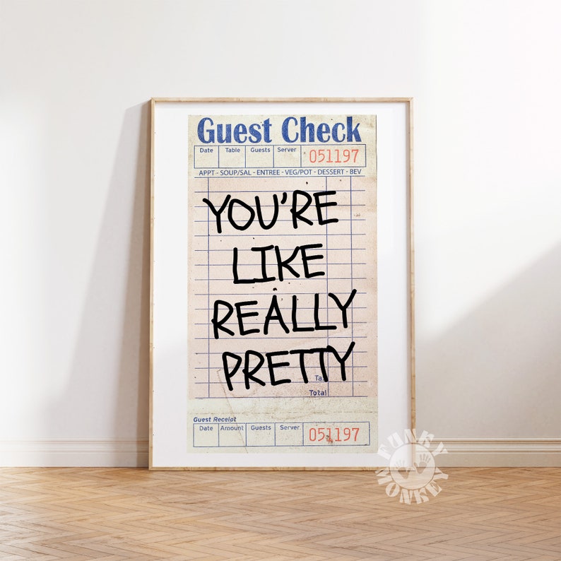 May include: A framed print of a vintage guest check with the text "YOU'RE LIKE REALLY PRETTY" written in black marker. The check has a blue and white design with the words "Guest Check" at the top and "051197" at the bottom.