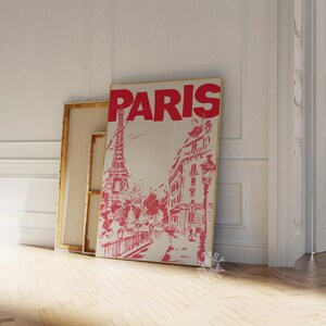 May include: A vintage-style poster with the word "PARIS" in bold red letters. The poster features a black and white illustration of the Eiffel Tower and a Parisian street scene.