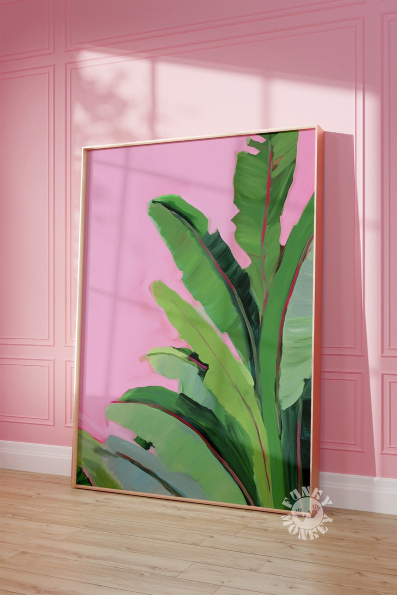 May include: A framed painting of green banana leaves on a pink background. The leaves are painted in a stylized, abstract style.