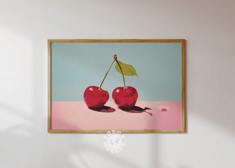 May include: Two red cherries with green stems and a single green leaf on a light blue and pink background.