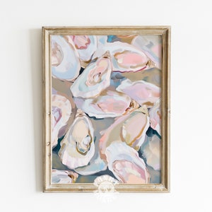 May include: A framed abstract painting of oyster shells in shades of pink, blue, and white. The shells are arranged in a random pattern, creating a textured and organic feel.