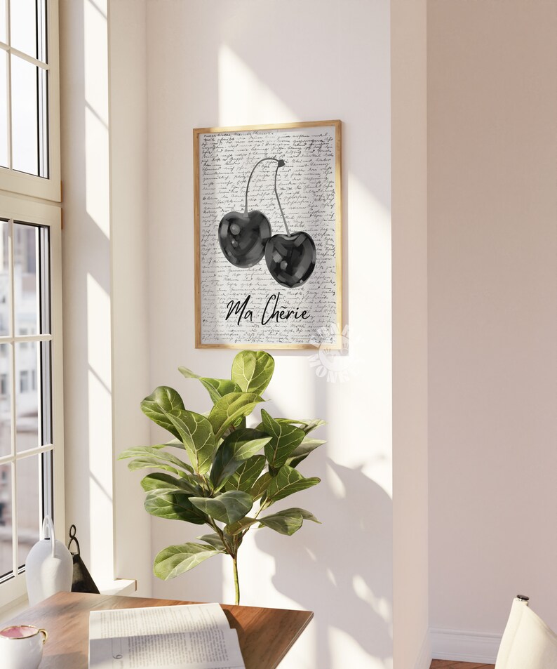 May include: Black and white watercolor print of two cherries with stems and leaves on a background of handwritten text. The text says "Ma Cherie".