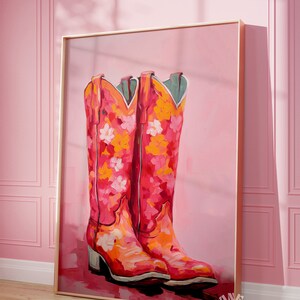 May include: A painting of a pair of pink cowboy boots with floral designs on a pink background.