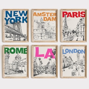 May include: Set of six black and white illustrations of famous landmarks in different cities. The illustrations are framed in light wood frames. The cities featured are New York, Amsterdam, Paris, Rome, Los Angeles, and London. The city names are written in colorful text on each frame.