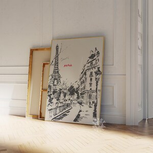 May include: A black and white sketch of the Eiffel Tower and Parisian buildings with the word "paris" in red lettering.