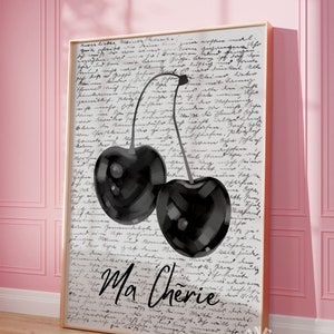 May include: A black and white illustration of two cherries with stems on a white background with handwritten text that says "Ma Cherie".