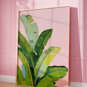 May include: A framed painting of green banana leaves against a pink background. The leaves are painted in a loose, impressionistic style.